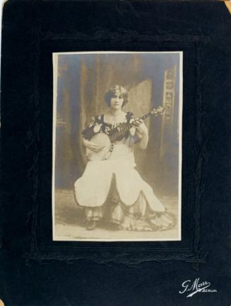 Woman seated with banjo