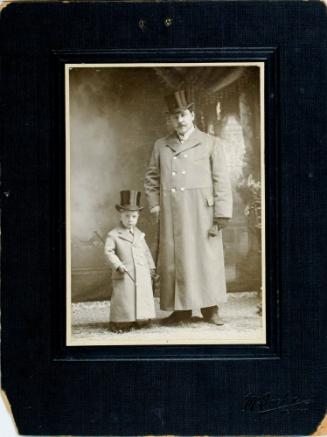 Young boy and Older man in full length coats