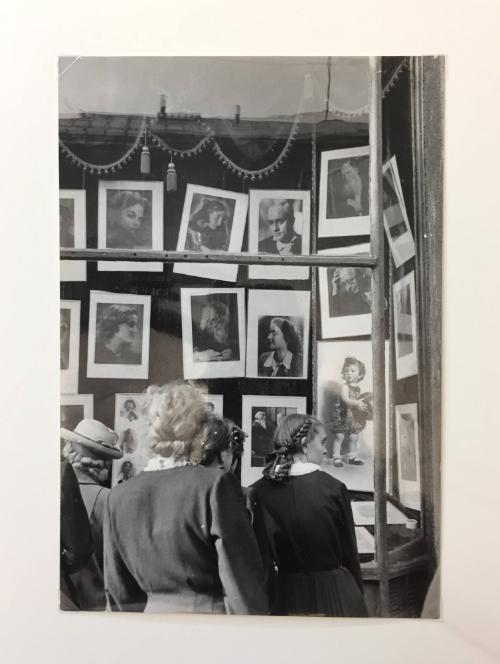 Women looking at photography studio window display, Moscow