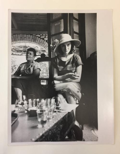 Portrait of a woman drinking in a bar in Haiti