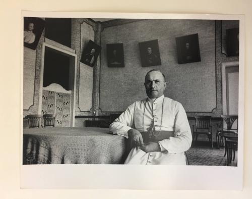 Catholic priest sitting in banquet room in Haiti