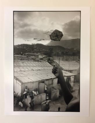 Cap Haitian (hand holding flag waving in the wind)