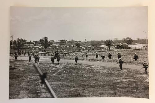 Soldiers walking in a field with camps, From the Life magazine story “Santo Domingo Civil War”