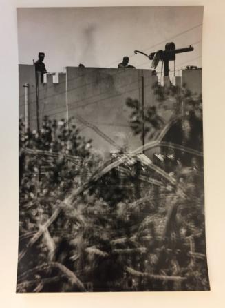 Soldiers looking over a tall stone wall with a machine gun, From the Life magazine story “Santo Domingo Civil War”