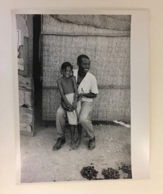 Smiling man and half-naked girl, Haiti