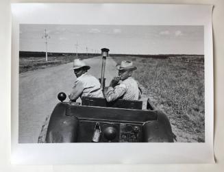 Two men in a tractor, Cuba