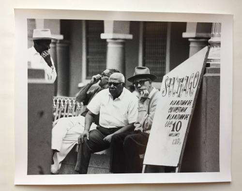 Men on street bench, Cuba
