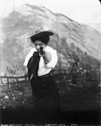May Lillie with Gun Aimed at Camera