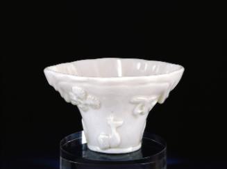 Cup (in rhinoceros-horn form with molded decoration of animals and plants)