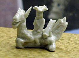 Figure riding mythical creature
