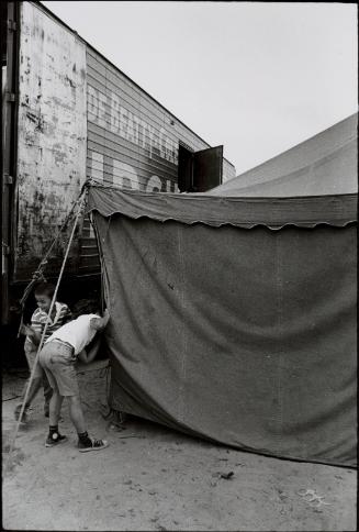 Jill Freedman (American, 1939 – 2019)
Boys peeking in tent (Circus Days), c. 1971
Gelatin sil…