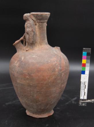 Red Slip jug with figure of Hermes on the shoulder holding a jug
