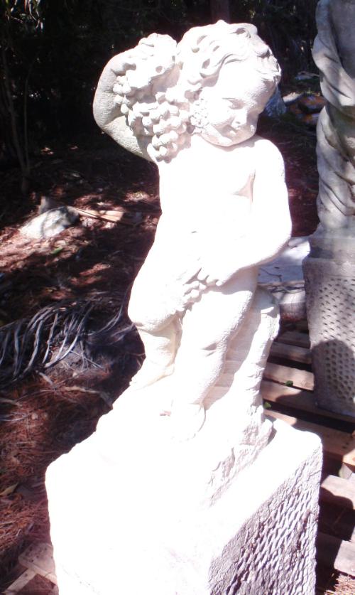 Putto with bunch of Grapes on right shoulder