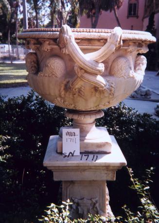 Urn with masks and twisted handles and base