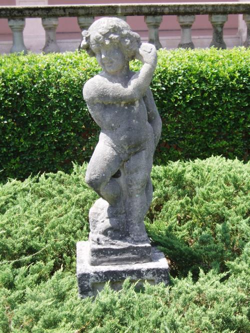 Putto holding something up to left ear