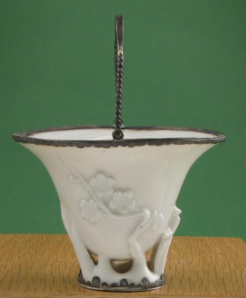 Cup with molded prunus design and silver fittings