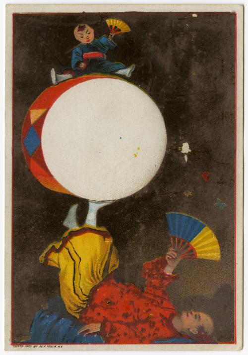 Man in Asian dress rolling drum with feet