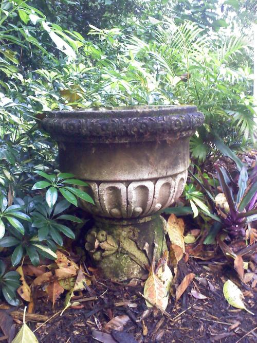 Urn with classical decoration Sitting atop another vase (not ID'd)