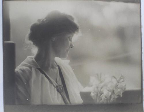 Woman with Flowers at Window