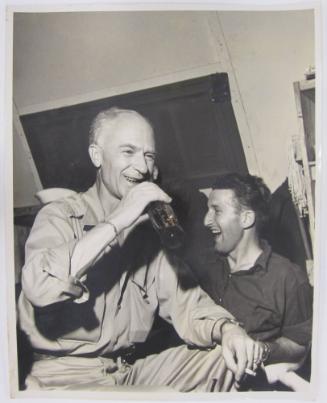 Ernie Taylor Pyle Sits Enjoying a Coca Cola and Smoking a Cigarette