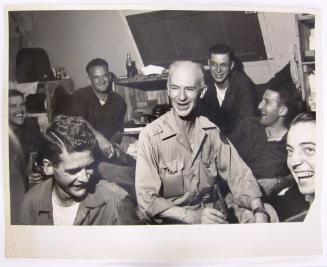 Ernie Taylor Pyle Sits and Laughs in a Social Group Enjoying a Coca Cola