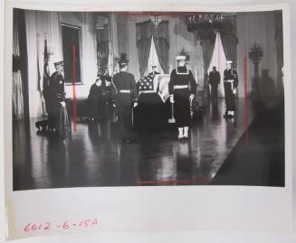 The Casket of John F. Kennedy, with Honor Guard and Praying Priest in the East Room of the White House