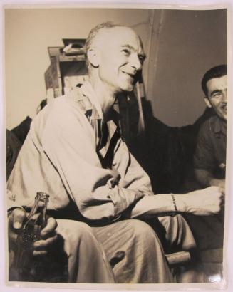 Ernie Taylor Pyle Sits and Smiles as Group of Men Enjoy Coca Cola