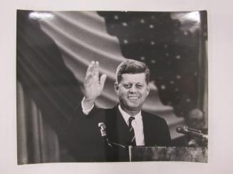 John F. Kennedy Waves from Podium
