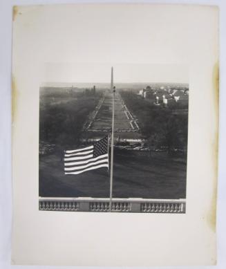 The Mall Beyond a United States Flag Flying at Half Mast on the U.S. Capitol Building