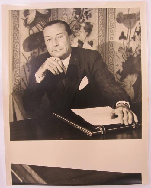 Man Sits at Desk while Enjoying a Cigarette