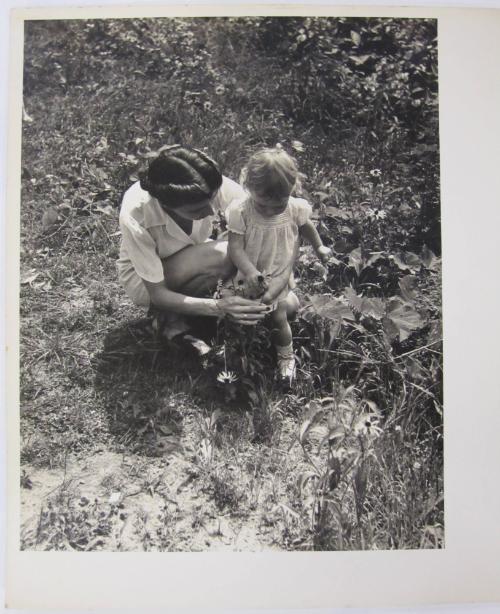 Woman and Child Exploring the Daisies