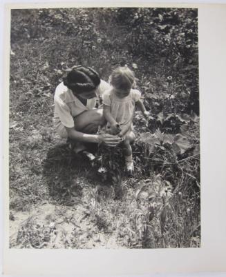 Woman and Child Exploring the Daisies