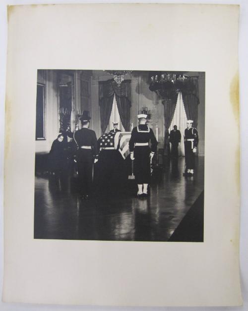 Casket of John F. Kennedy, with Honor Guard and Praying Priest in the East Room of the White House