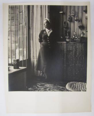 Woman Looks Out Through Bamboo Lined Window