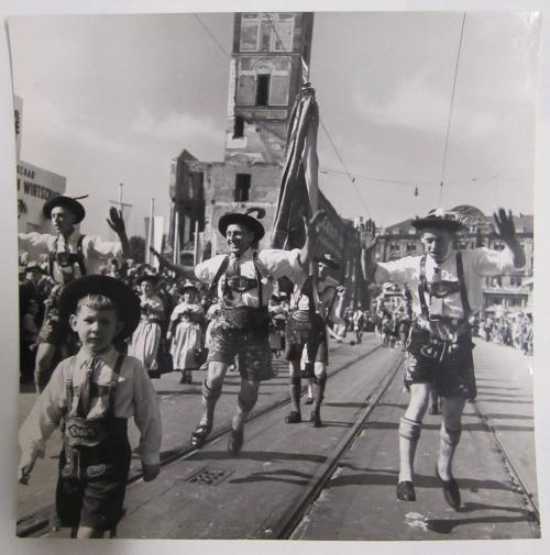 Men in Lederhosen Dance on Railway Tracks