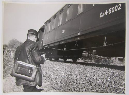 Man Stands Next to Freedom Train with Brief Case