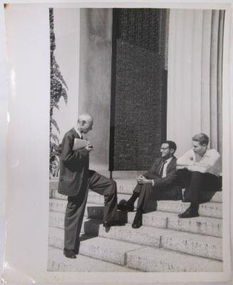 Three Men Conversing on Steps