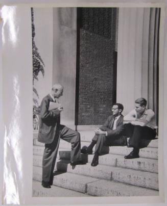 Three Men Conversing on Steps