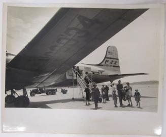 Group Exits Pan-Am Airplane on Tarmac