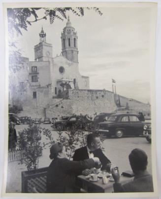 Group of Three Enjoy a Seaside Tea with a Castle or Church in Background