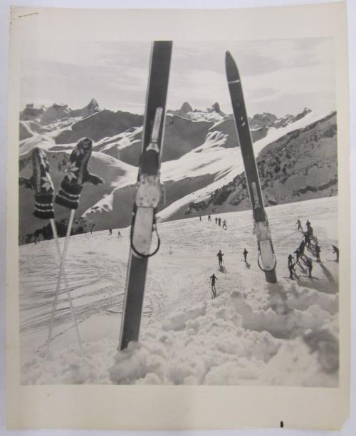 Snow Covered Mountain with Skis and Ski Poles Lodged in Snow