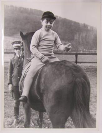 Boy Seated Backwards on Horse