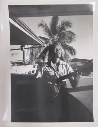 Man Plays Guitar on Terrace