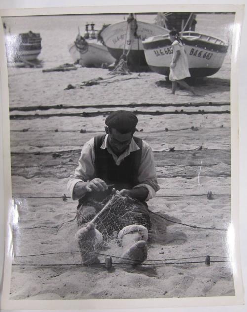 Man Repairs Fish Nets