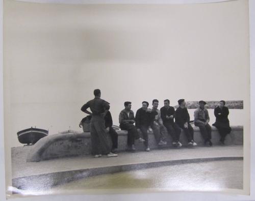 Group Sits and Converses on Sea Wall