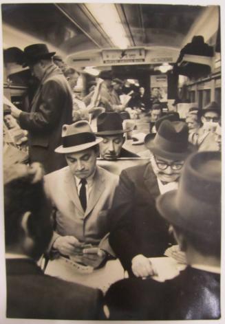 Men Play Cards in Busy Train
