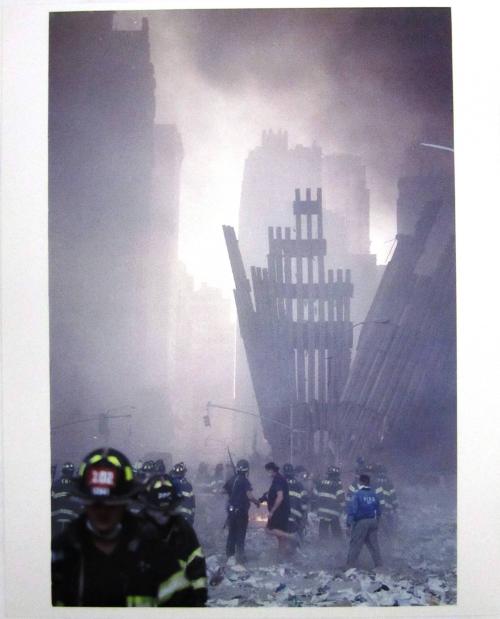 Firefighters Peering at the Ash and Rubble after the Collapse of the World Trade Center Towers, September 11, 2001