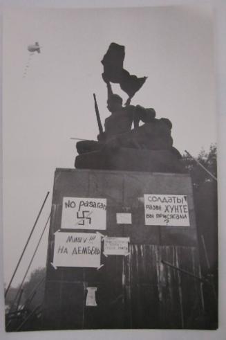 Communist Slogan from the Spanish Civil War, "No Pasaron," and Other Messages Adhered to Base of Sculpture of Soldiers. Zeppelin at Upper Left