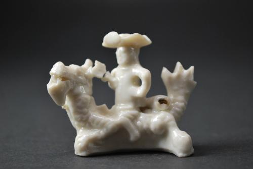 European figure with mythical creature