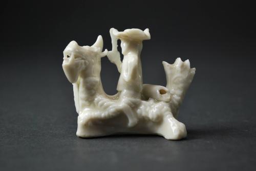 Figure with mythical creature